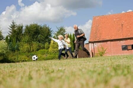 grandfather and kids playing football