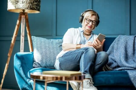 Senior woman listening to the music at home