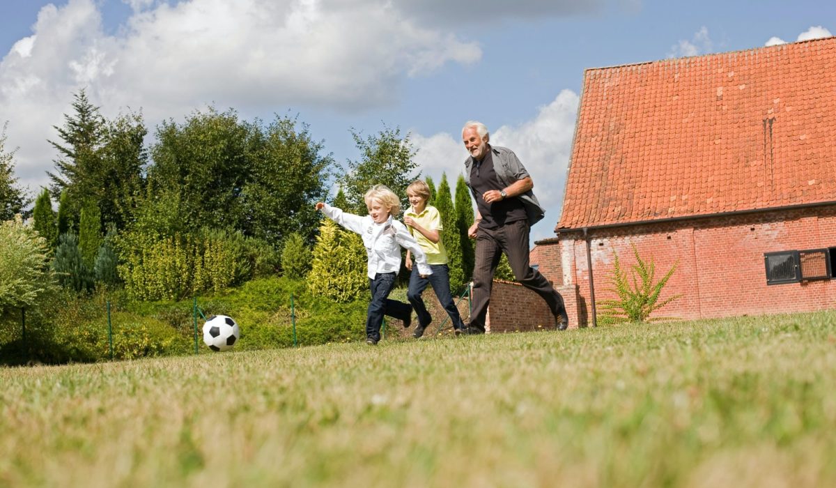 grandfather and kids playing football