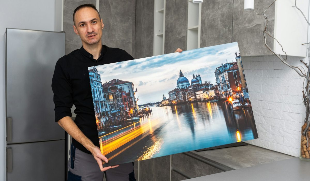 Photo canvas print. A man holding a photography with gallery wrap